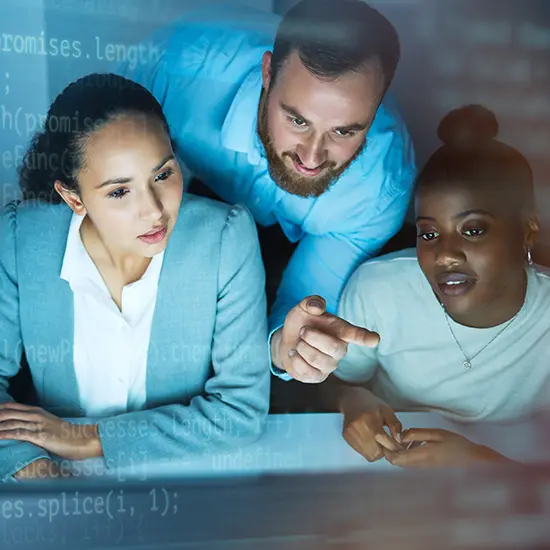 Designing Integration That Fits Your Workflows Team reviewing a workflow on screen with a subtle code overlay, collaborating on AI integration that fits existing processes