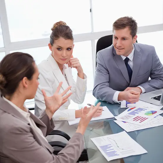 Team reviewing charts and data during a strategic research consulting session, outlining the organizational assessment approach
