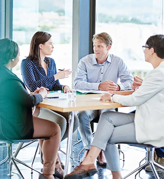 Team meeting reviewing processes and performance data during an organizational assessment as part of strategic research consulting