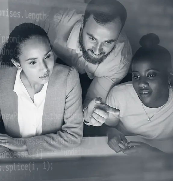 Diverse team reviewing a screen together while a leader points out changes, designing AI integration that fits real workflows