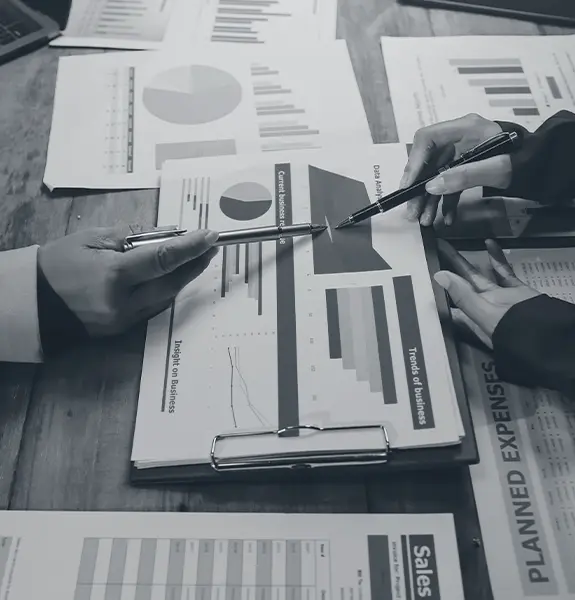 Hands reviewing market analysis charts and opportunity assessment data