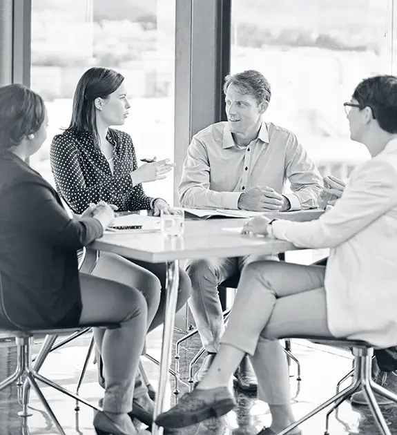 Team conducting organizational effectiveness evaluation during workplace meeting